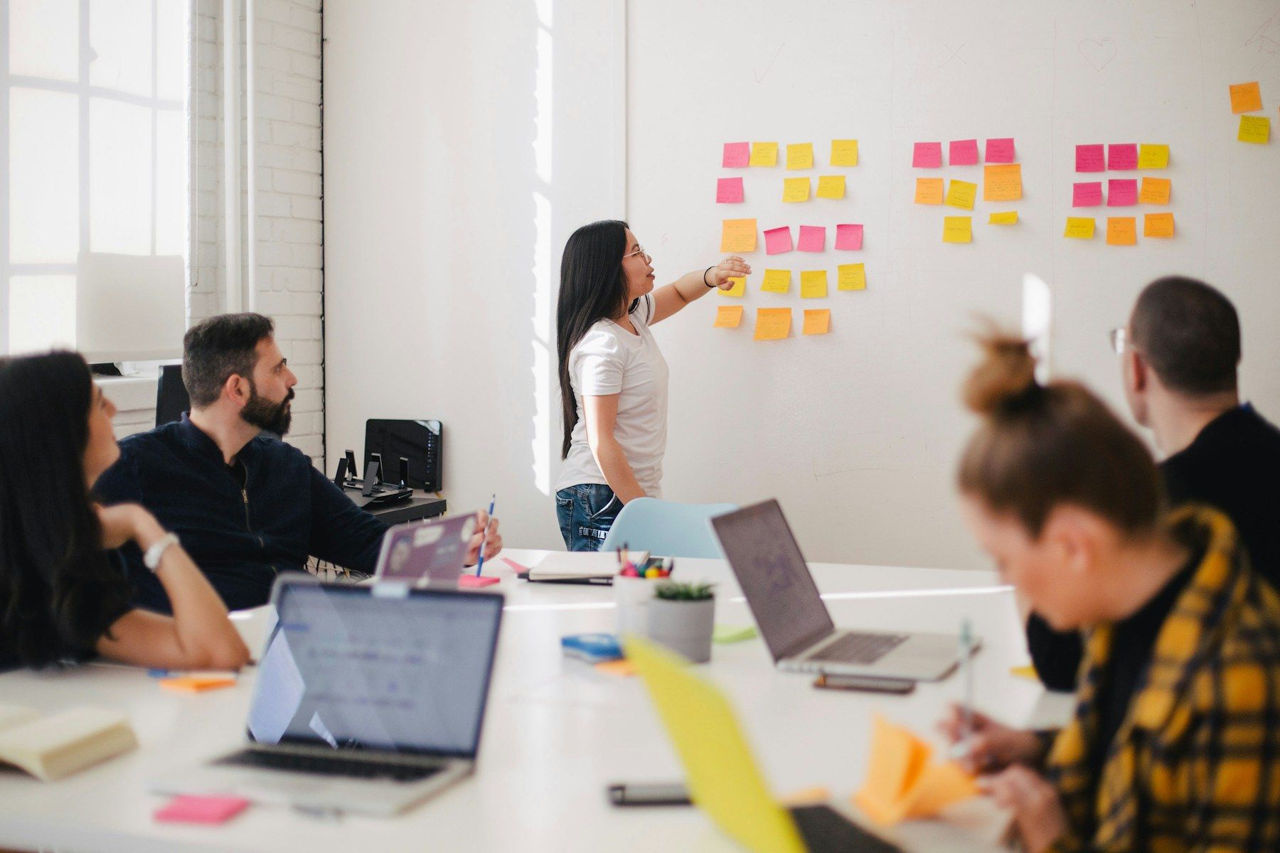 A product team mapping user journeys with sticky notes during a discovery workshop